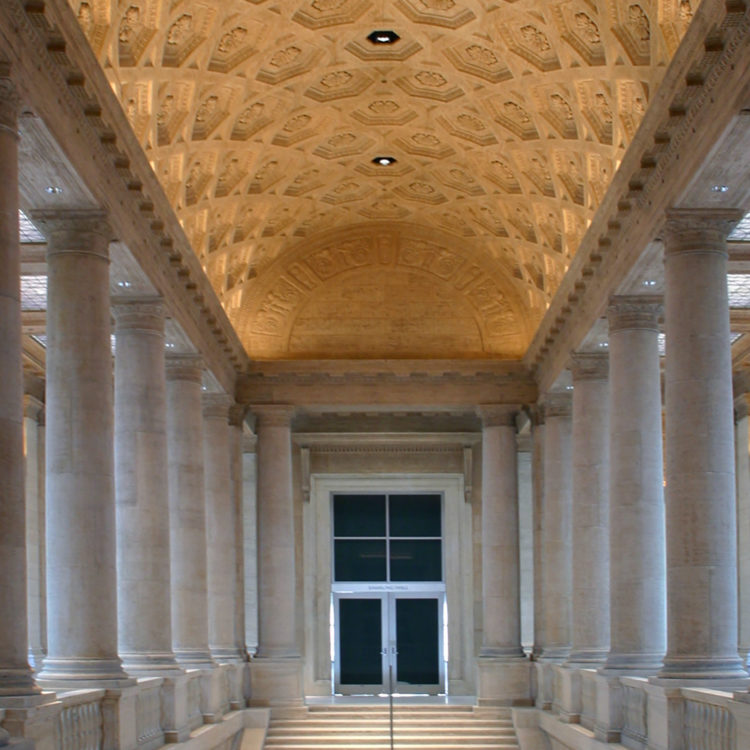 Image of stairs leading up to double doors, with an illuminated ornate ceiling overhead