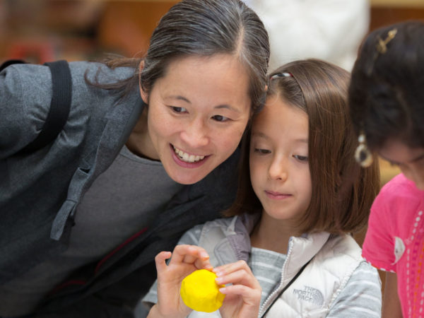 A woman and a child doing crafts at the museum.