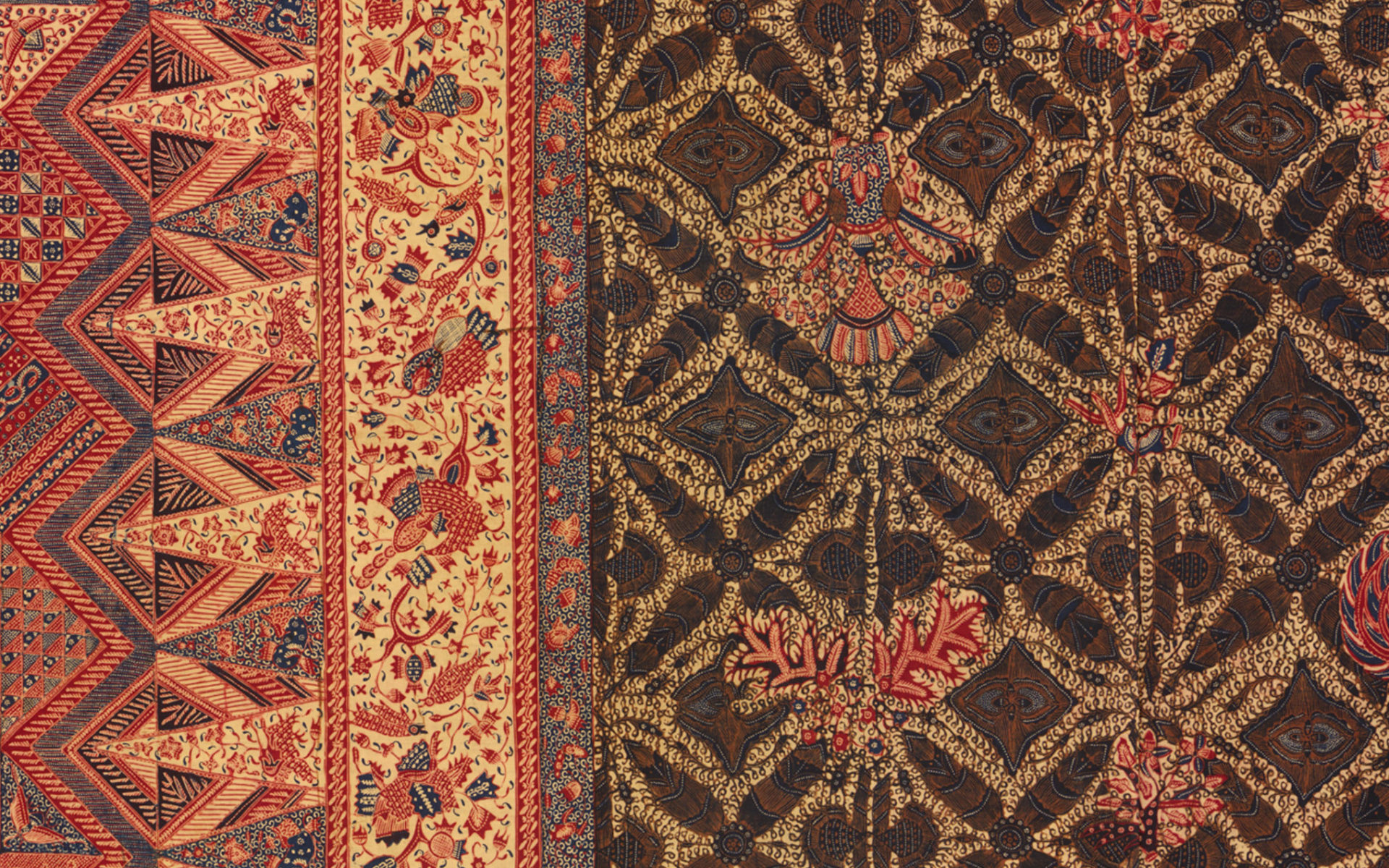 Close up of an Indonesian textile, patterned in red, green and gold.