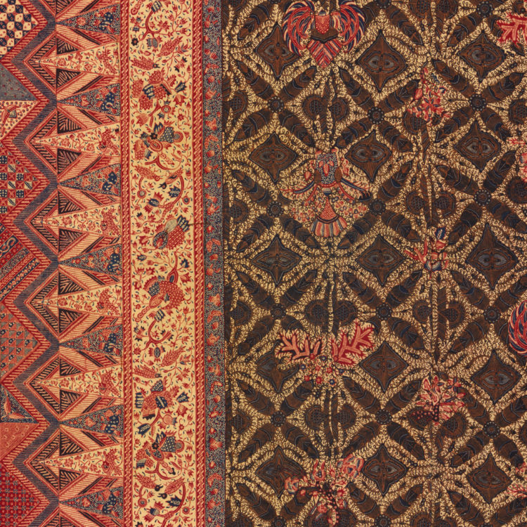 Close up of an Indonesian textile, patterned in red, green and gold.