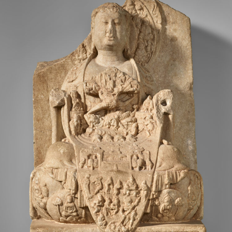 Marble carving of a seated figure with an elaborately decorated robe.