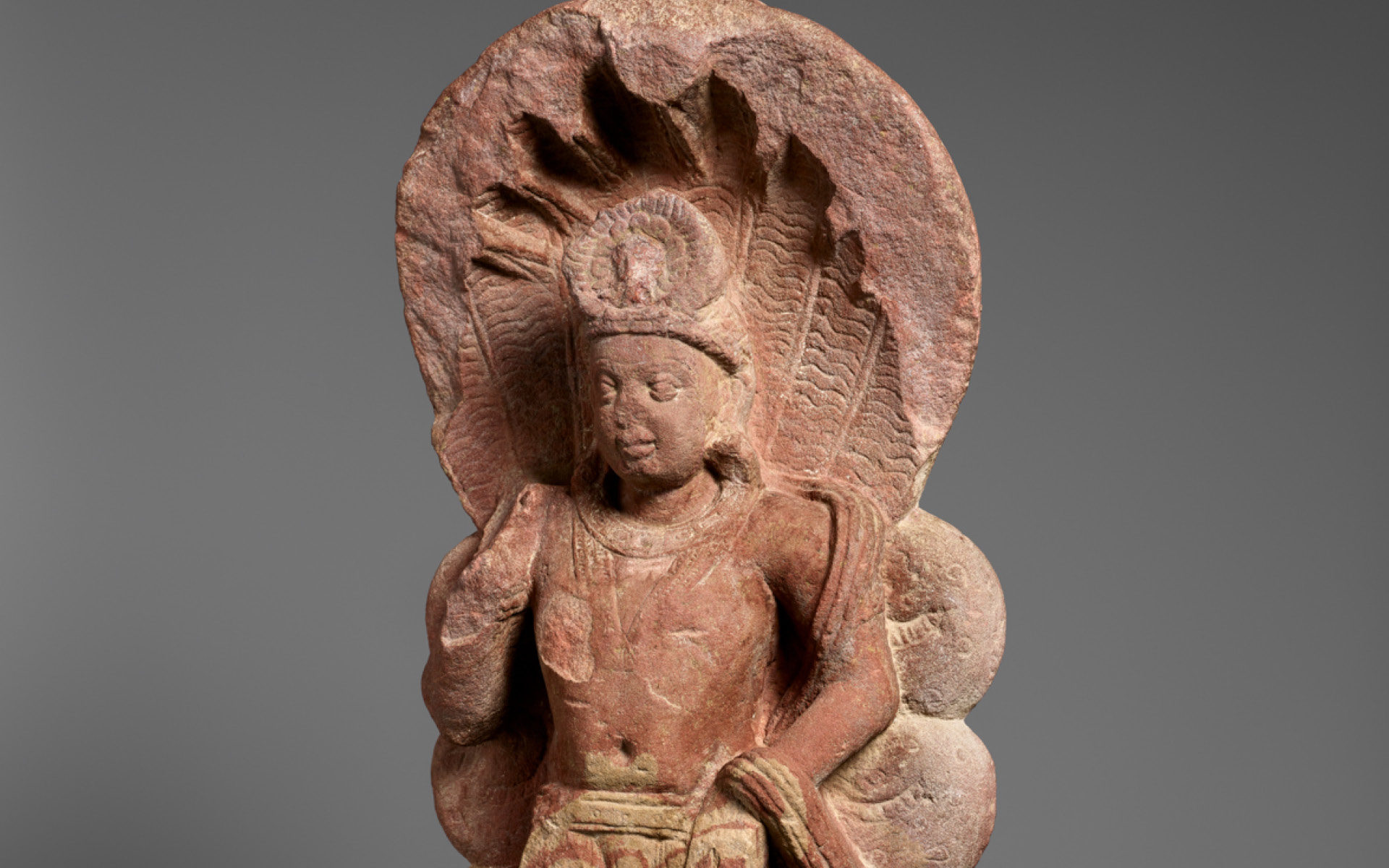 Sandstone sculpture of a serpent king.