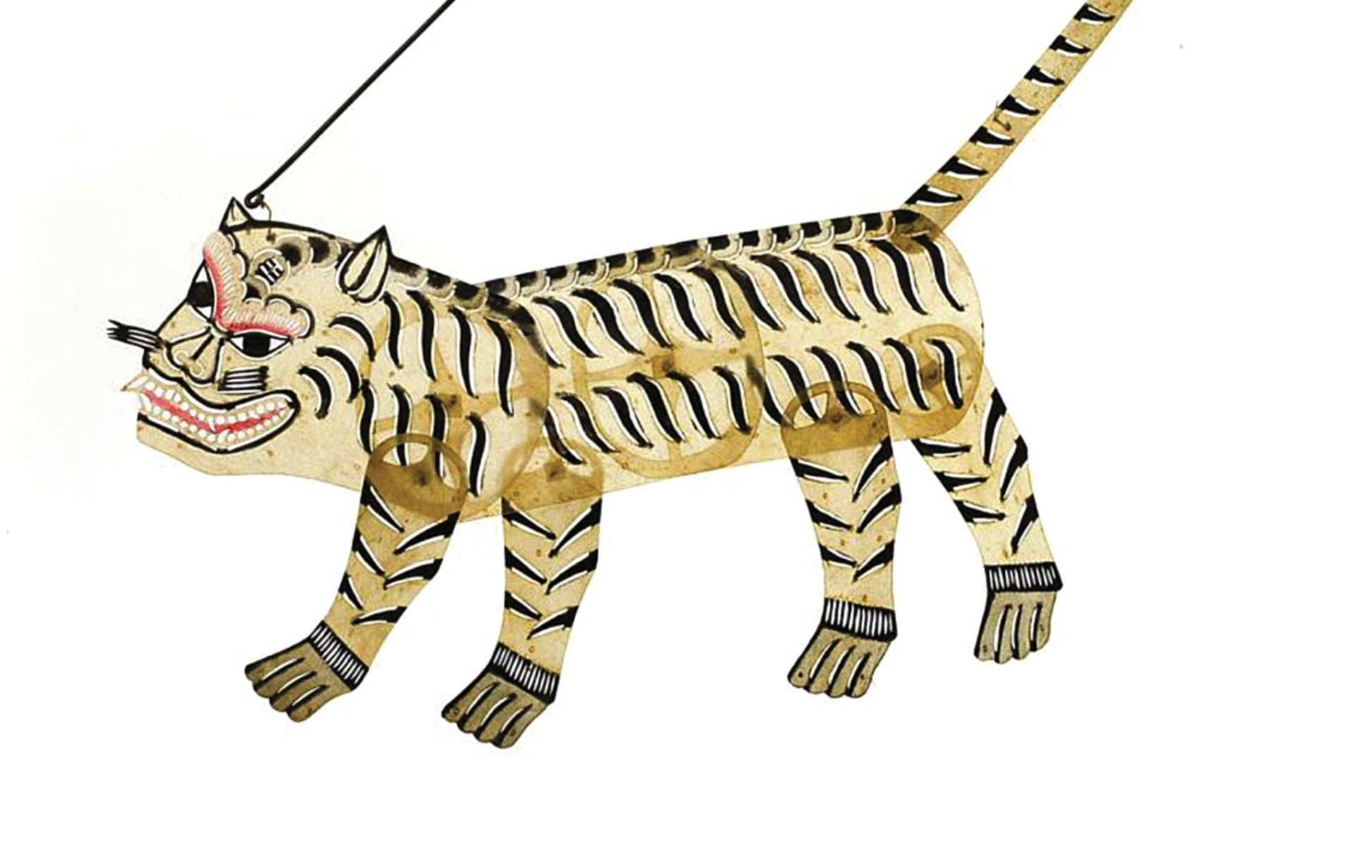 Small, semi-translucent puppet in the shape of a tiger. Light yellow with thin black stripes and a long, pointy tail.  
