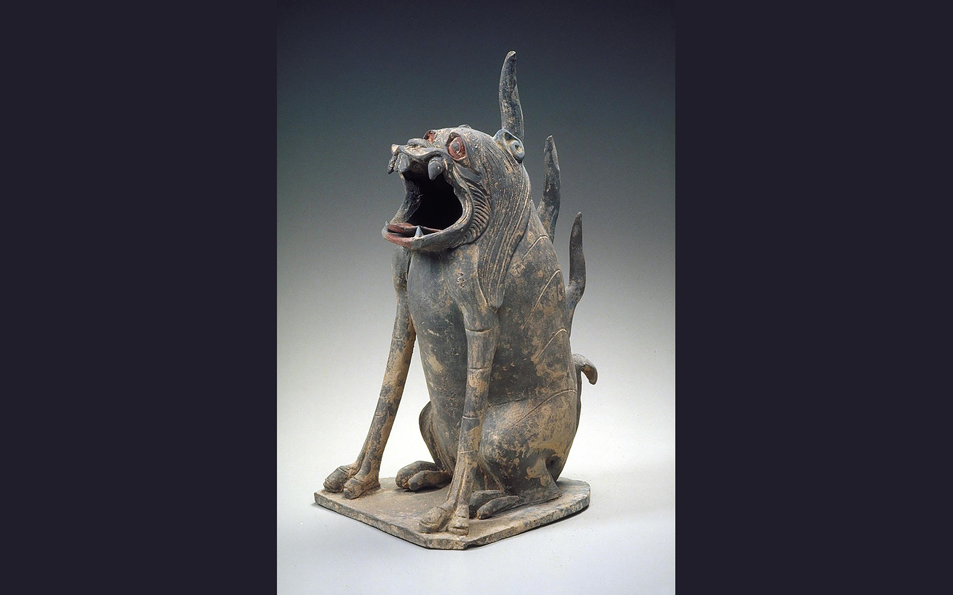 Ceramic dog-like animal in grey clay.
