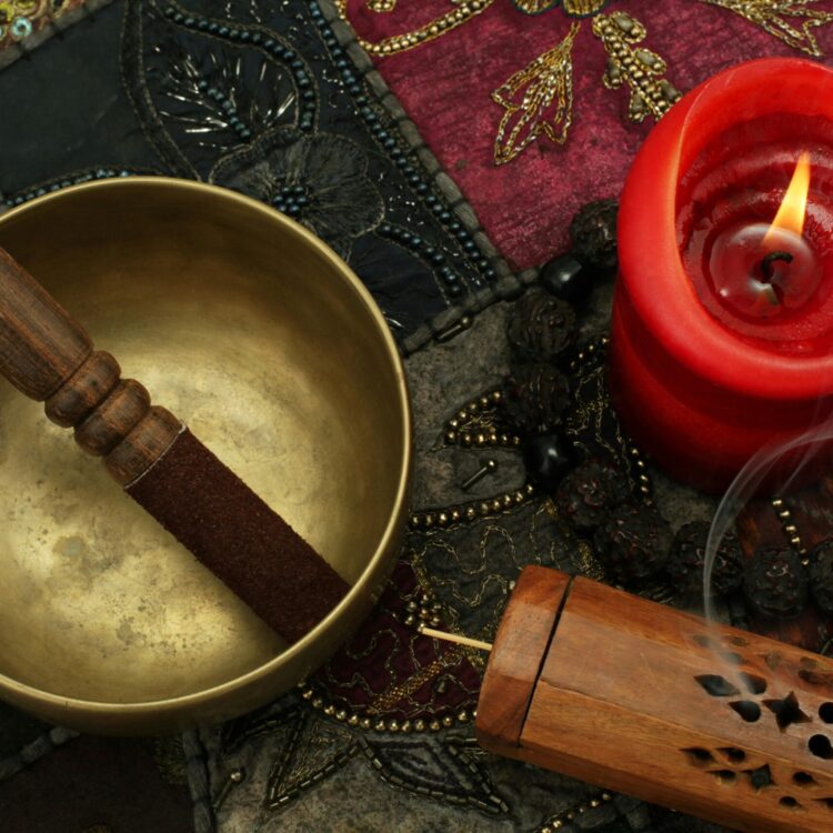 A photographic collage of a singing bowl, candle and textiles used in sound healing.